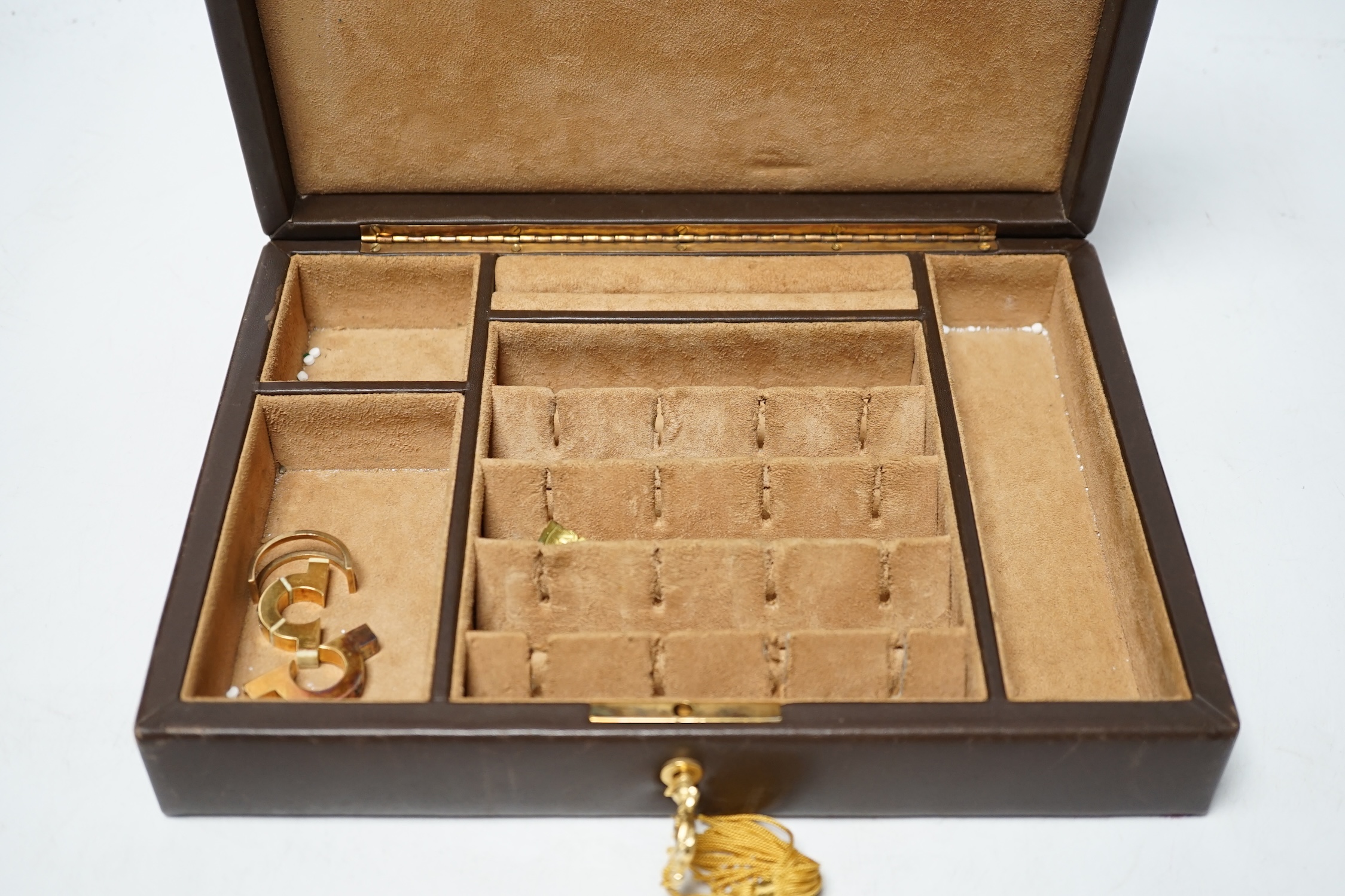 A Harrods brown leather cufflink box with stirrup handle, together with and yellow metal and three stone diamond and ivory set clip?, a similar sapphire set clip and one other clip. Condition - poor to fair CITES Submiss